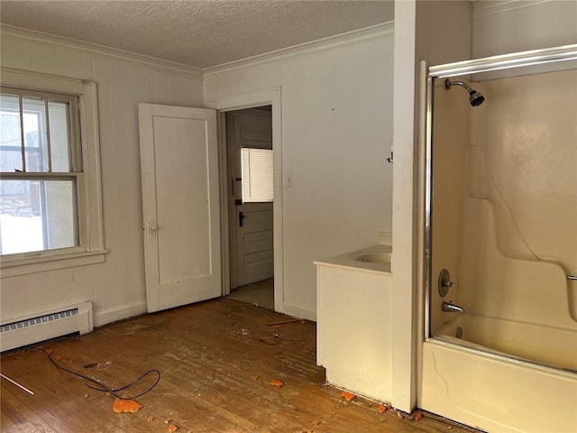 4512 Terrace St, Kansas City, MO 64111 - bathroom with hardwood / wood-style floors, ornamental molding, shower / washtub combination, and a baseboard heating unit