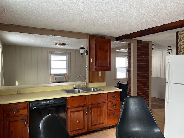 4512 Terrace St, Kansas City, MO 64111 - kitchen featuring light hardwood / wood-style floors, wooden walls, sink, black dishwasher, and white fridge