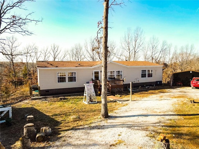 view of front of home featuring a carport and a deck