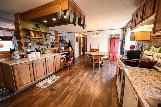 kitchen featuring light stone counters, dark hardwood / wood-style flooring, a notable chandelier, decorative light fixtures, and range