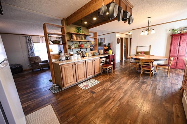 kitchen featuring dark hardwood / wood-style flooring, a textured ceiling, a notable chandelier, beamed ceiling, and hanging light fixtures