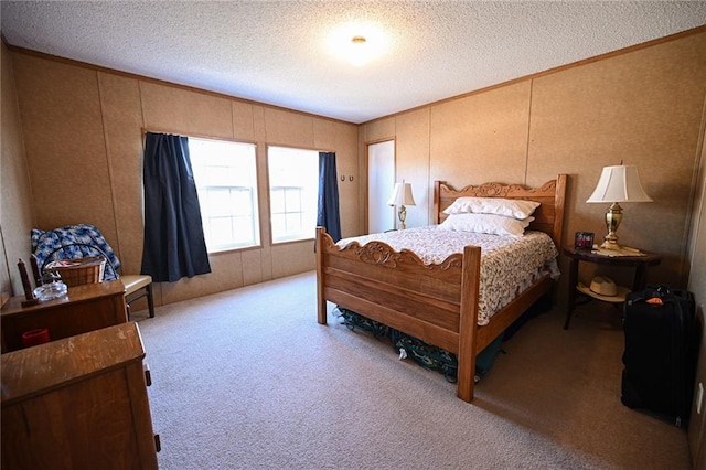 carpeted bedroom featuring a textured ceiling and crown molding