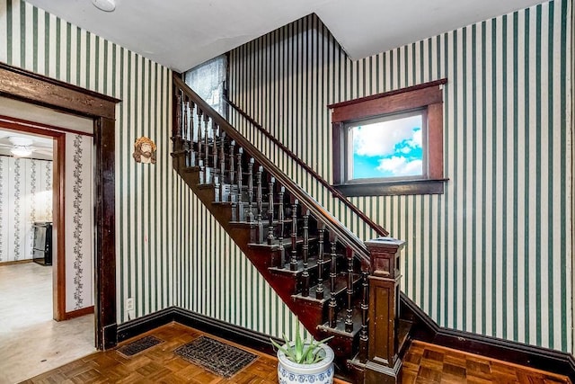 staircase featuring parquet floors