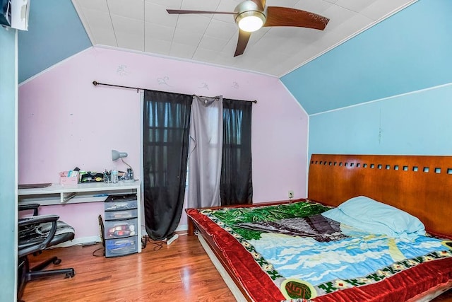 bedroom with ceiling fan, vaulted ceiling, and wood-type flooring