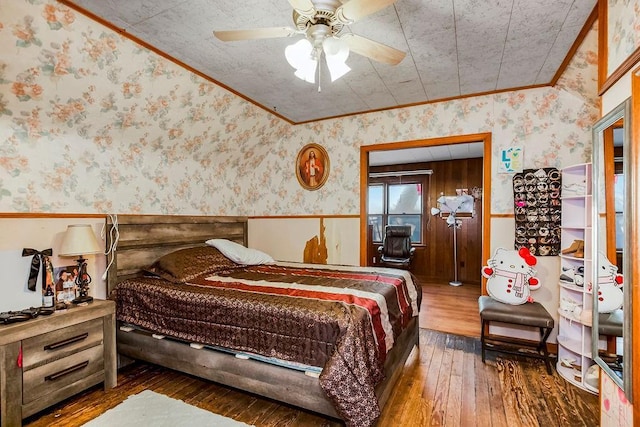 bedroom with crown molding, dark wood-type flooring, and ceiling fan