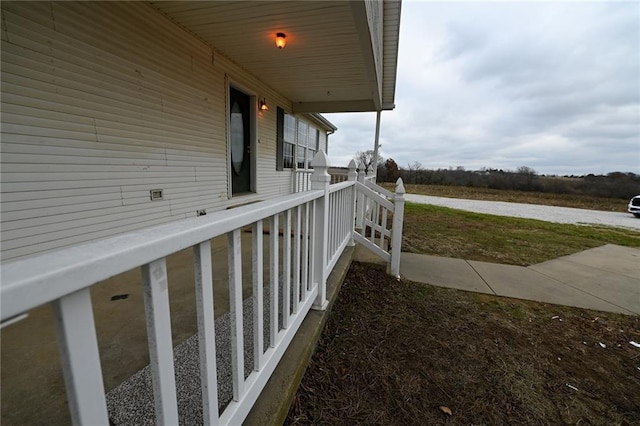 view of side of property featuring covered porch