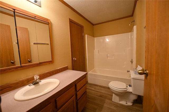 full bathroom featuring crown molding, shower / bath combination, wood-type flooring, a textured ceiling, and toilet