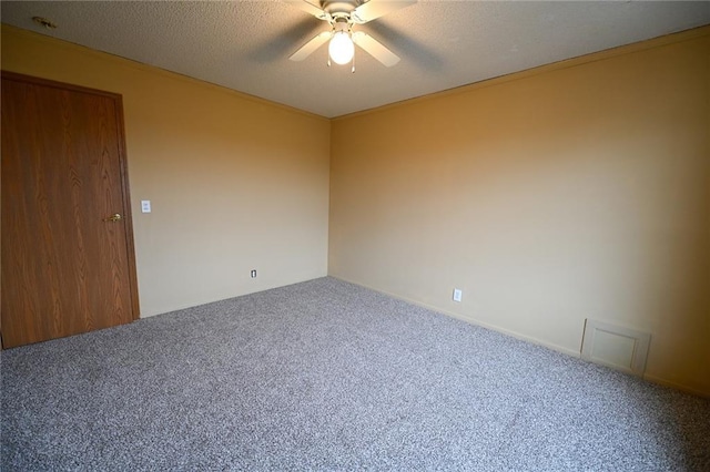 empty room with carpet, a textured ceiling, and ceiling fan