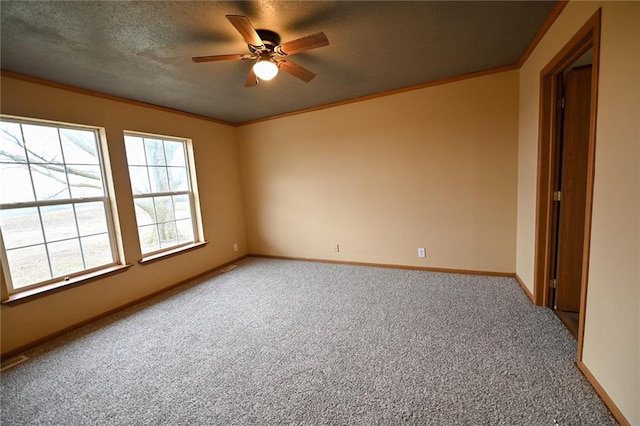 carpeted empty room with ceiling fan and ornamental molding