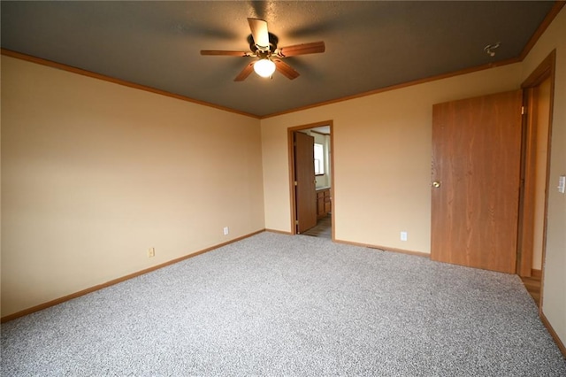 unfurnished bedroom with connected bathroom, ceiling fan, crown molding, and carpet floors