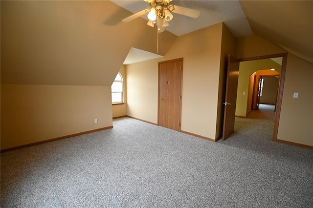 bonus room featuring ceiling fan, carpet, and lofted ceiling