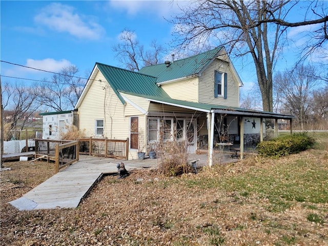 rear view of house with a patio area and a wooden deck