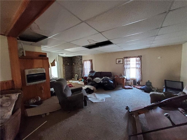 living room featuring carpet, a paneled ceiling, and heating unit