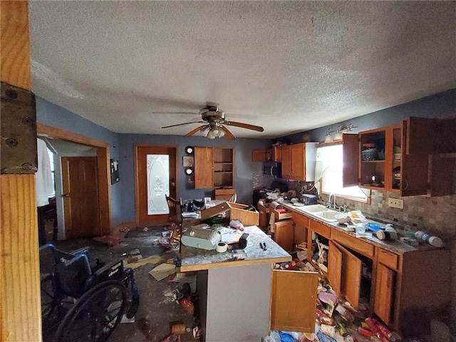 misc room with a textured ceiling, ceiling fan, and sink