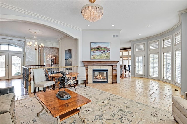 living room with crown molding and a chandelier