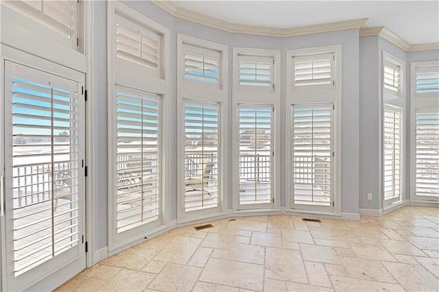 doorway featuring ornamental molding and a high ceiling