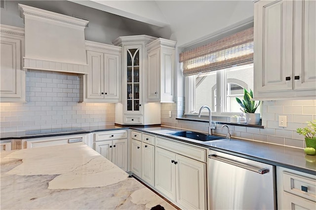 kitchen with black electric stovetop, sink, stainless steel dishwasher, and decorative backsplash