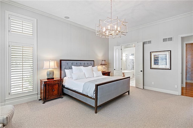 bedroom with crown molding, a chandelier, light colored carpet, and ensuite bath