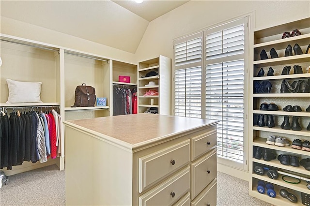 spacious closet with vaulted ceiling and light carpet