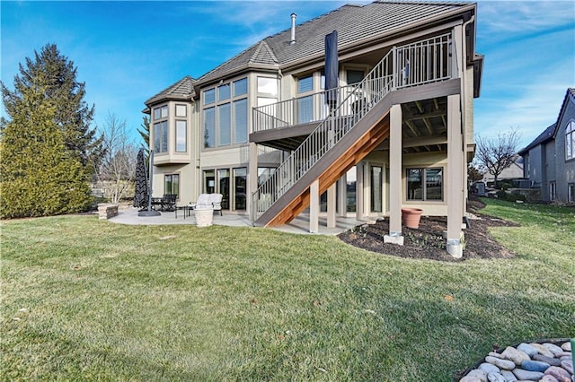 back of house featuring a yard and a patio