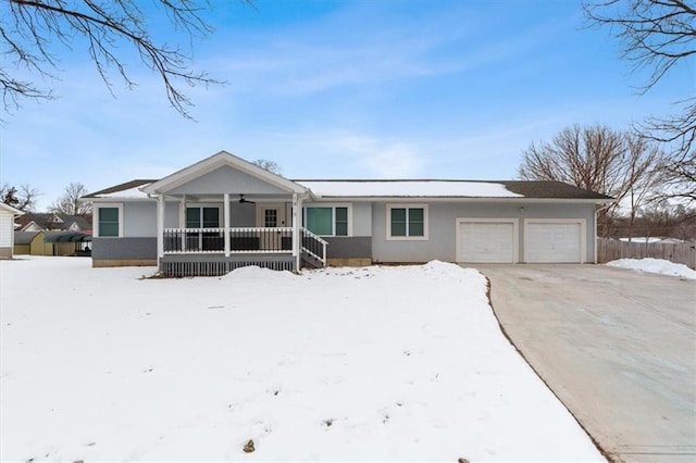 ranch-style house featuring a garage and covered porch