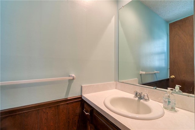 bathroom featuring vanity and a textured ceiling