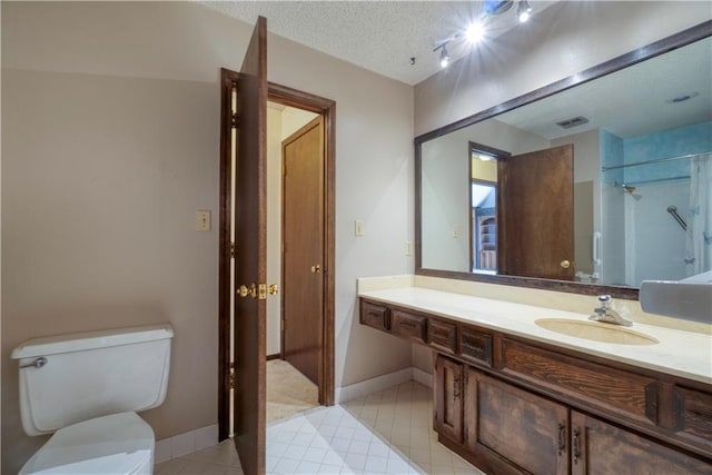 bathroom with visible vents, baseboards, toilet, vanity, and a textured ceiling