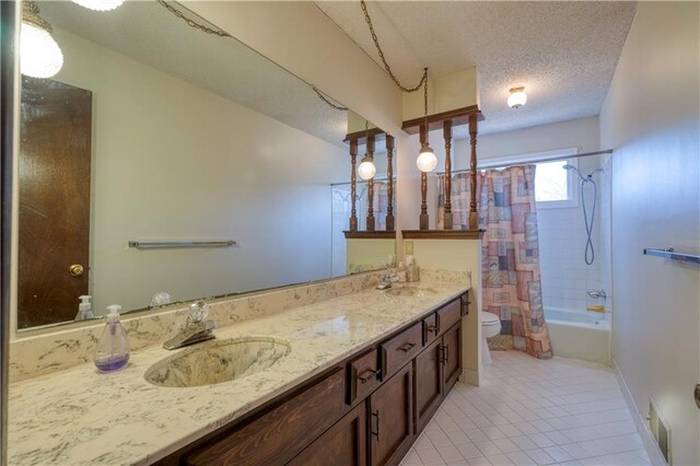 full bath featuring tile patterned flooring, a sink, toilet, a textured ceiling, and shower / bathtub combination with curtain