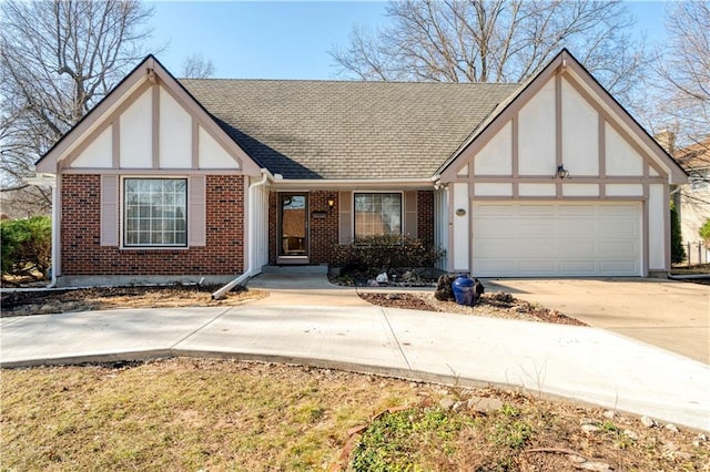 tudor home featuring brick siding, concrete driveway, roof with shingles, stucco siding, and an attached garage