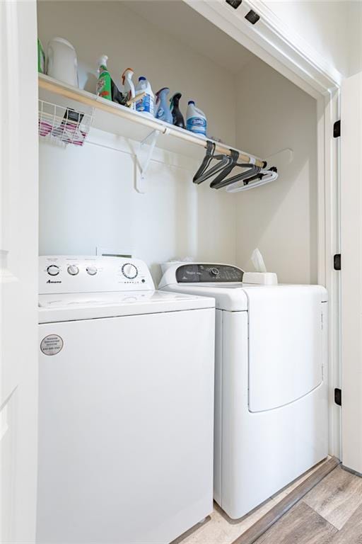 washroom featuring light wood-type flooring and washing machine and dryer