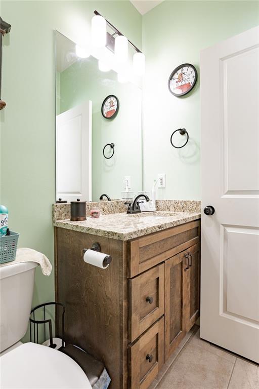 bathroom with tile patterned floors, vanity, and toilet