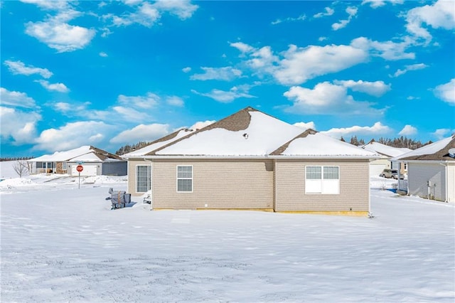 view of snow covered rear of property