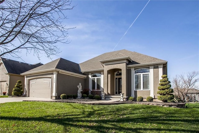 view of front of house featuring a garage and a front lawn