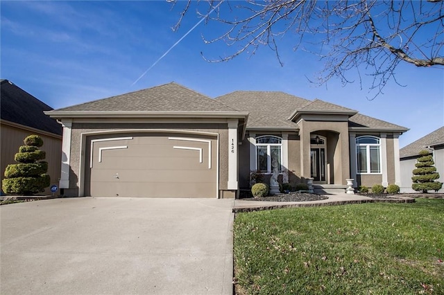 view of front of house with a garage and a front lawn