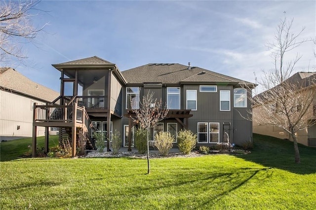 back of property with a sunroom and a lawn