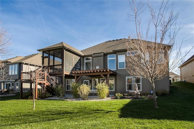 back of house featuring a sunroom and a lawn