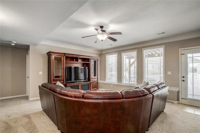 living room featuring light carpet, a textured ceiling, ceiling fan, and crown molding