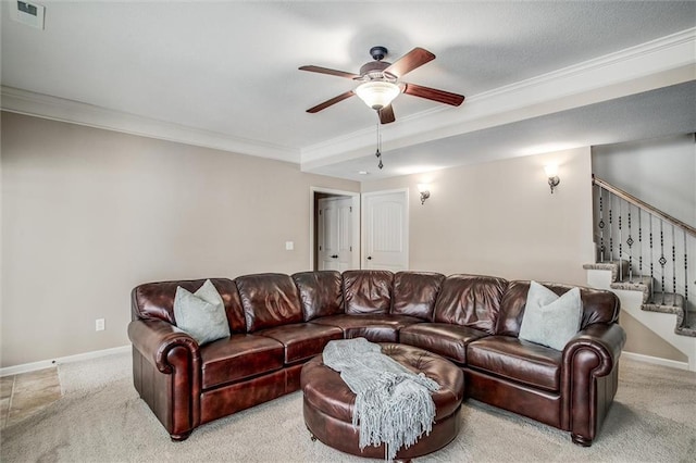 living room featuring ceiling fan, light colored carpet, and ornamental molding