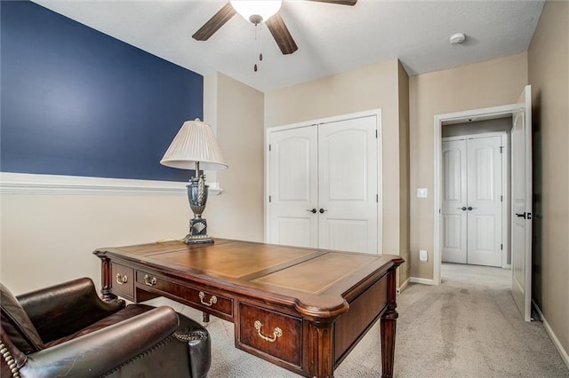 carpeted office with ceiling fan