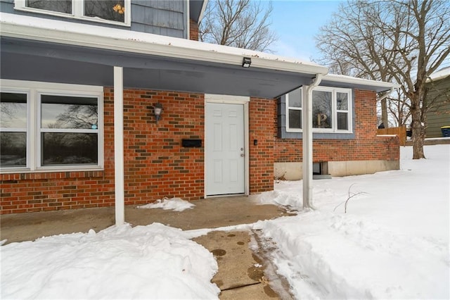 view of snow covered property entrance