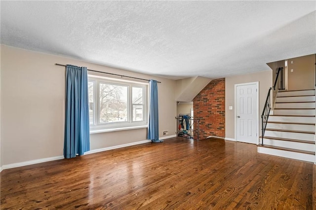 unfurnished living room with hardwood / wood-style floors and a textured ceiling