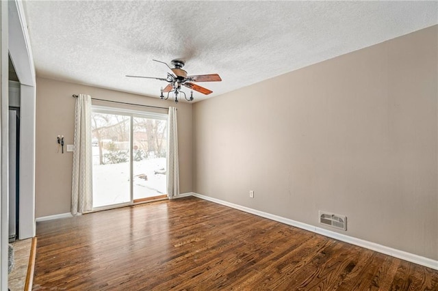 unfurnished room featuring ceiling fan, dark hardwood / wood-style flooring, and a textured ceiling