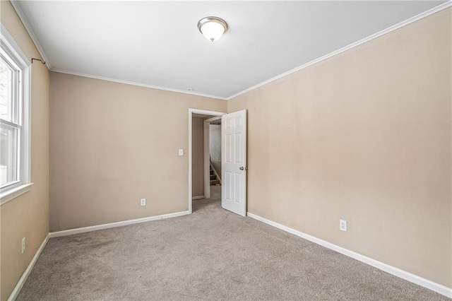 empty room with light colored carpet and ornamental molding