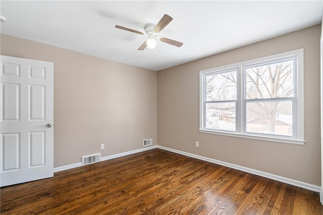 spare room featuring ceiling fan and dark hardwood / wood-style flooring