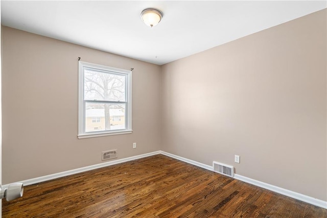 spare room with dark wood-type flooring