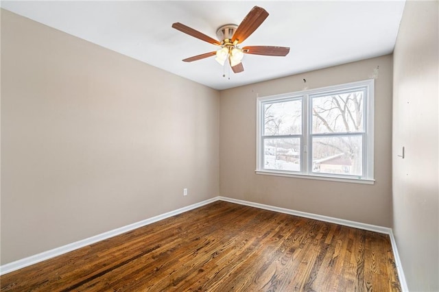 empty room featuring dark hardwood / wood-style floors and ceiling fan