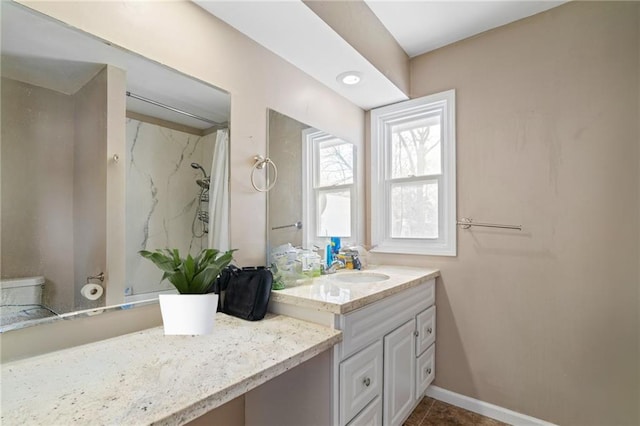 bathroom with tile patterned floors, vanity, toilet, and curtained shower