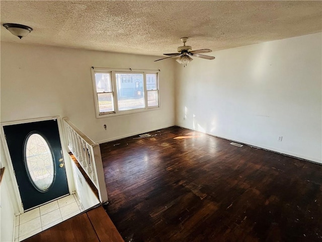 unfurnished living room with light wood-type flooring, a textured ceiling, and ceiling fan