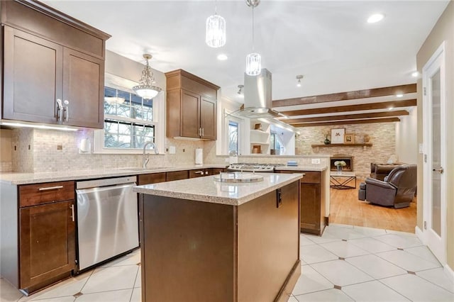 kitchen with stainless steel dishwasher, sink, beam ceiling, a center island, and hanging light fixtures