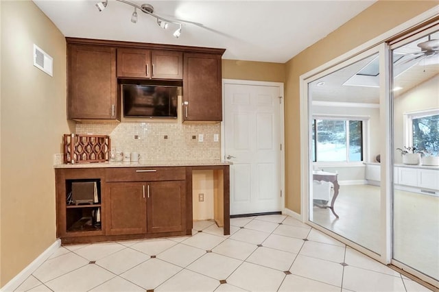 kitchen featuring decorative backsplash and ceiling fan